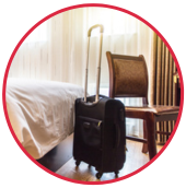 a chair and rolling suitcase in a hotel room